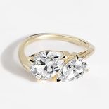 A yellow gold toi et moi ring with a pear and marquise stone.
