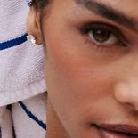 A woman with a round stud earring