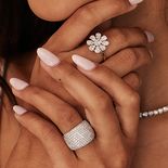 A woman with large statement rings on each hand.