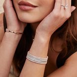 A woman with bracelets on both arms.